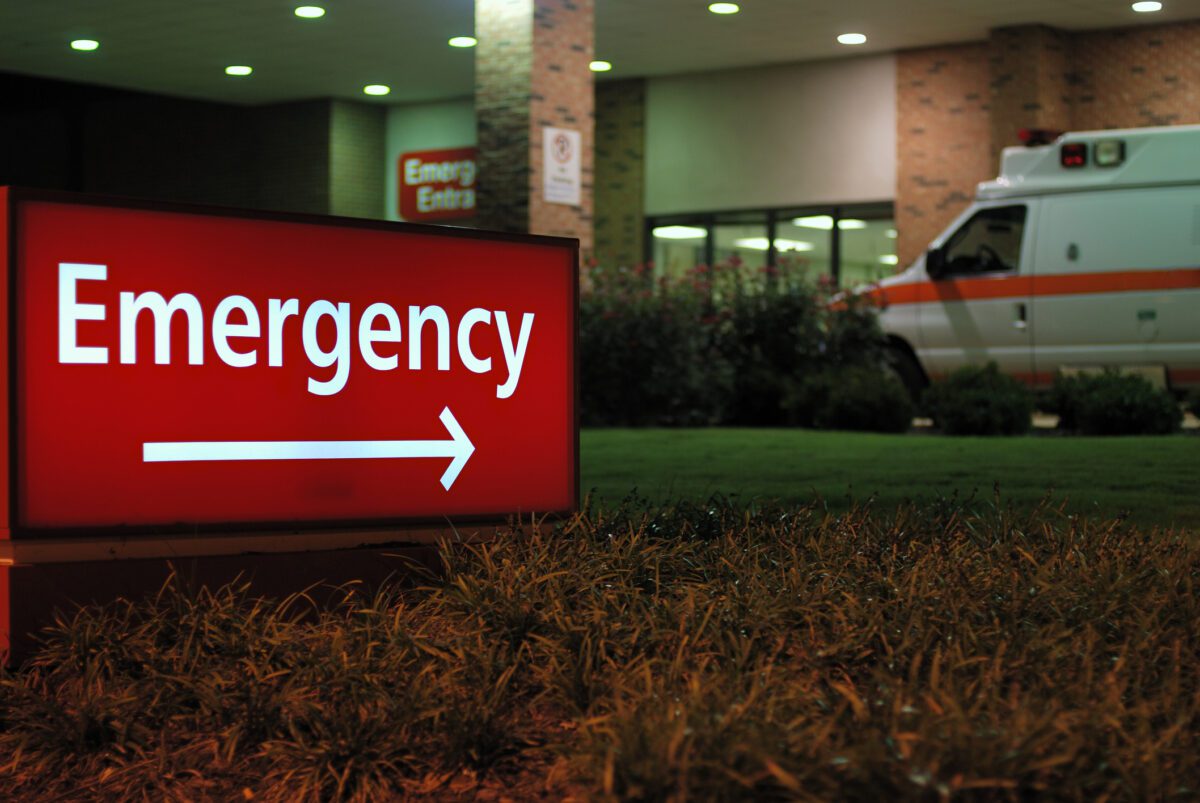 Emergency room entrance at night with ambulance.