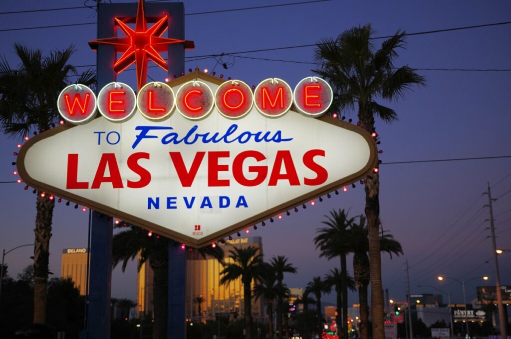 Welcome to Las Vegas sign lit up against night sky backdrop.