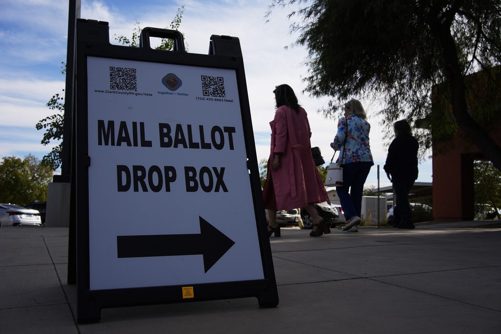 People walk out of a polling place after voting, Wednesday, Oct. 30, 2024, in Las Vegas. (AP Photo/John Locher)