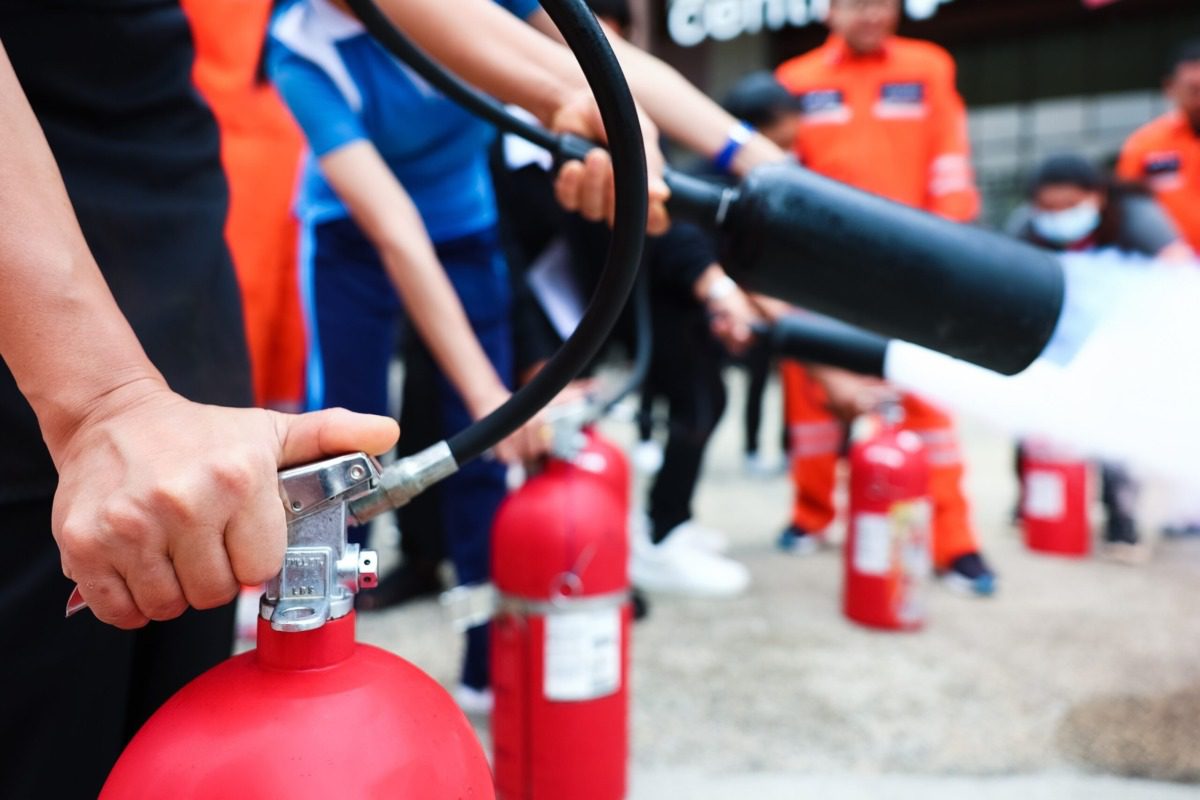 Students learning how to use fire extinguishers.